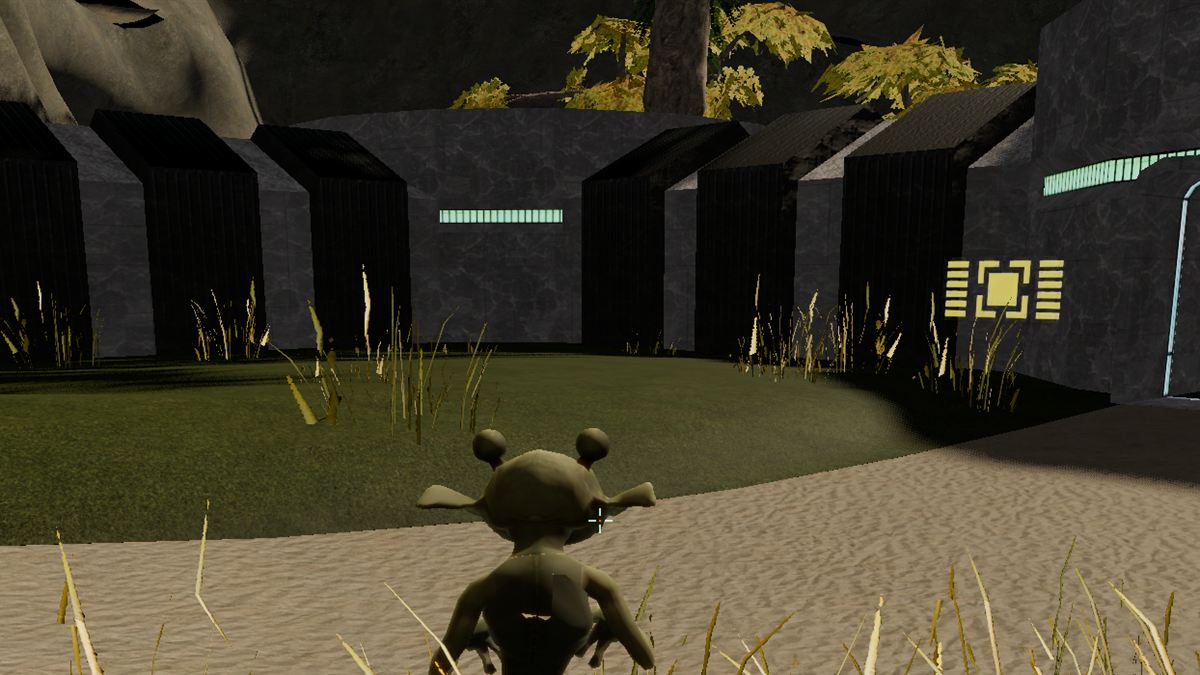 A grassy courtyard before a dark, lit building